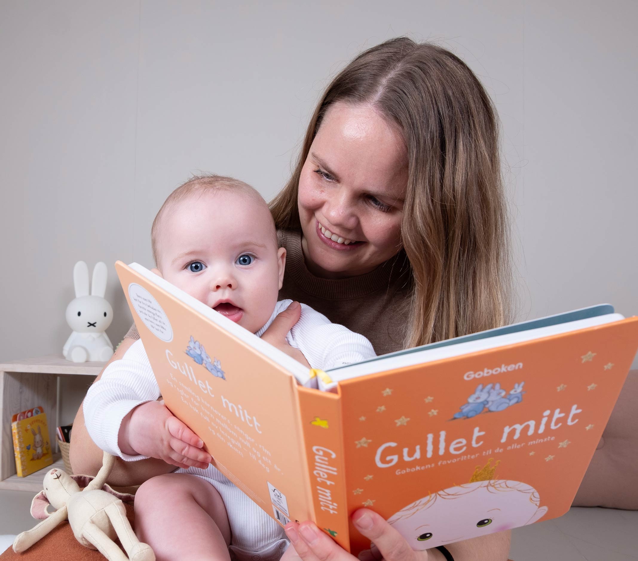 Mor og baby som leser en bok